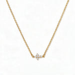 A Steadfast Grace Sideways Cross with White Cubic Zirconia Necklace by Skōsh Jewelry, featuring a small sideways cross accented with clear stones on a fine gold chain, displayed against a white background.