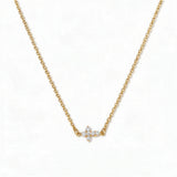A Steadfast Grace Sideways Cross with White Cubic Zirconia Necklace by Skōsh Jewelry, featuring a small sideways cross accented with clear stones on a fine gold chain, displayed against a white background.