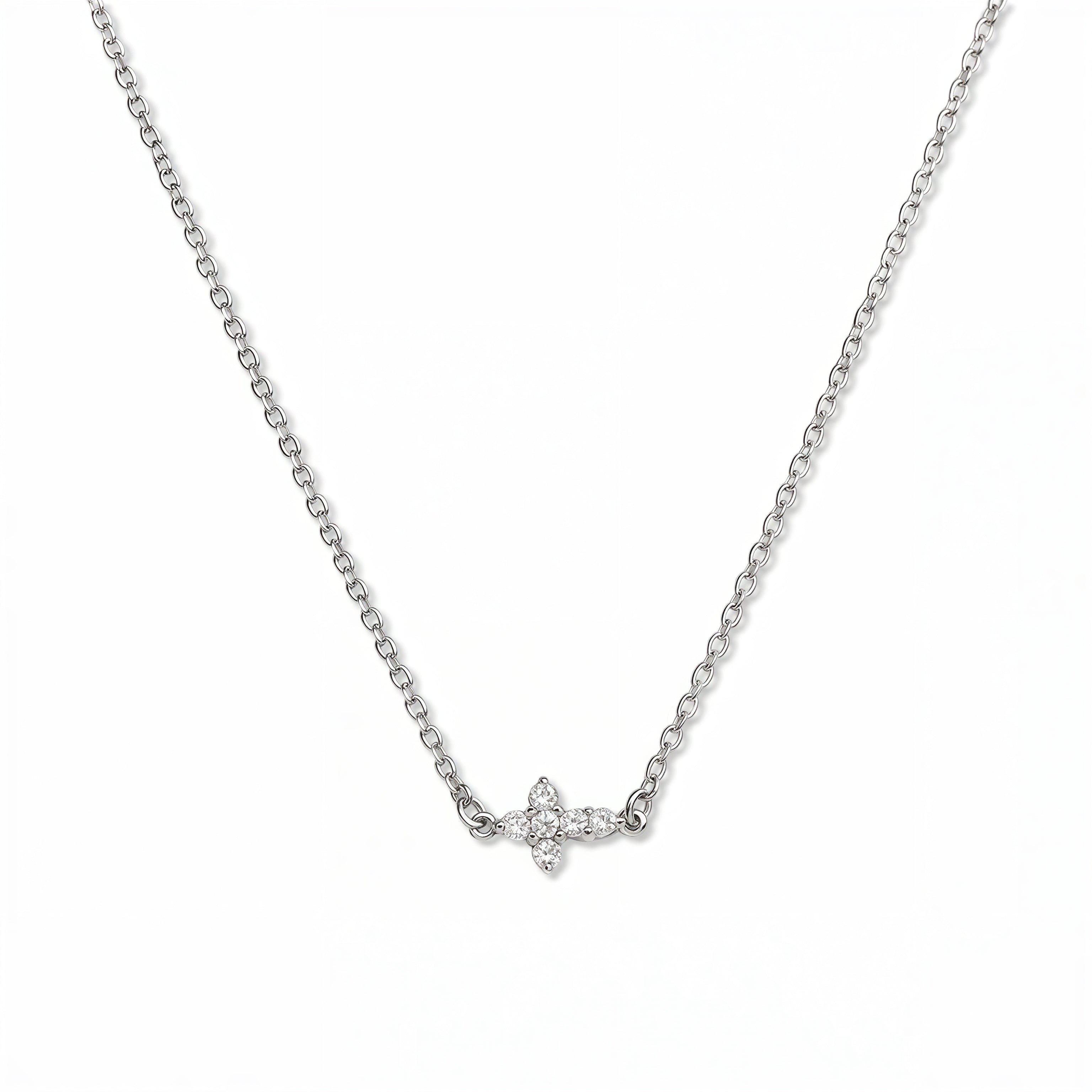 A Steadfast Grace Sideways Cross with White Cubic Zirconia Necklace by Skōsh Jewelry, featuring a small sideways cross accented with clear stones on a fine sterling silver chain, displayed against a white background.