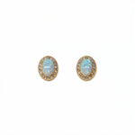 A pair of Ethereal Opal with White Cubic Zirconia Halo Earrings by Skōsh Jewelry, featuring oval iridescent opals framed by halos of small clear stones in gold, displayed against a white background.
