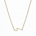 An Unbreakable Wave Necklace by Skōsh Jewelry, featuring a curling ocean wave shape set sideways on a fine gold chain, displayed against a white background.