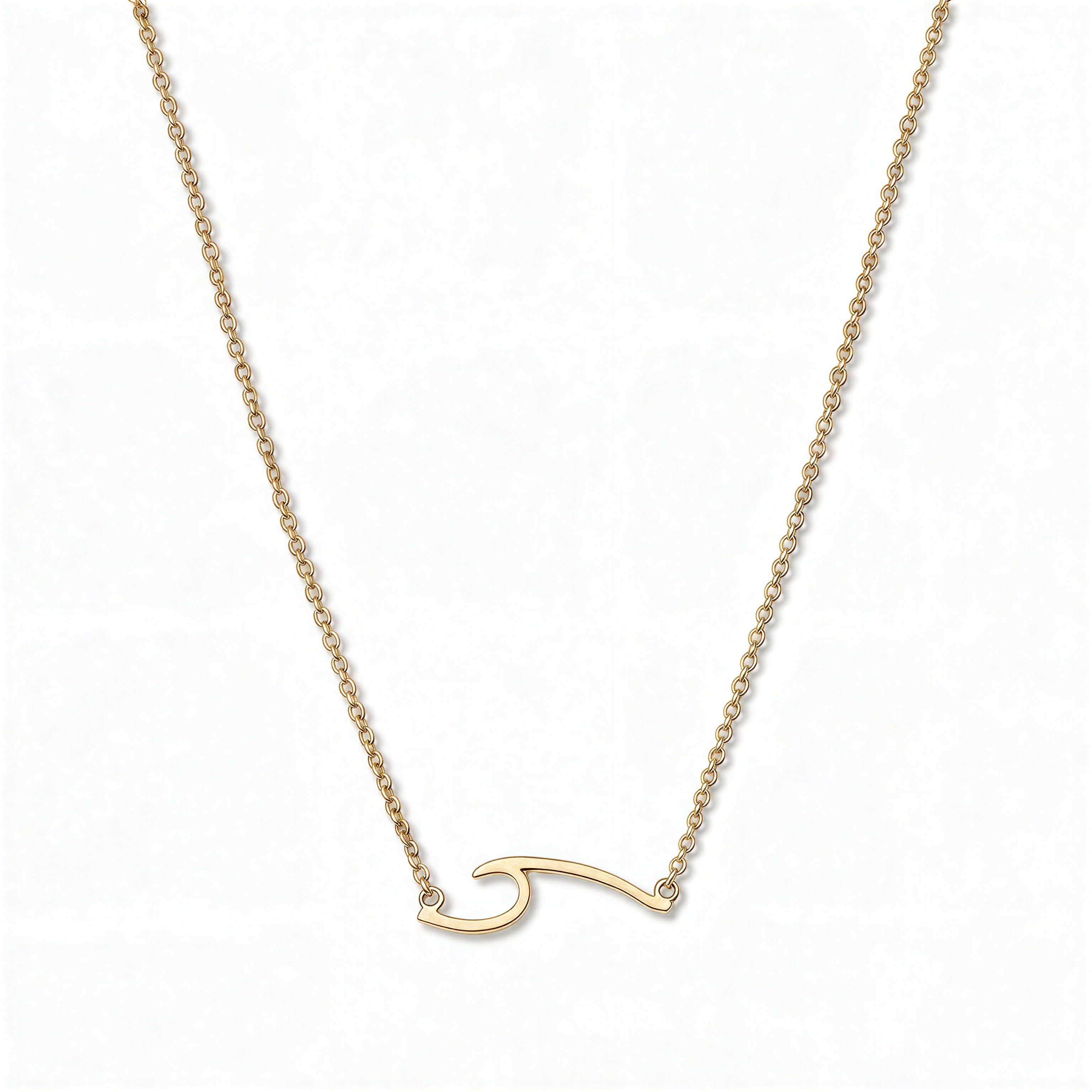 An Unbreakable Wave Necklace by Skōsh Jewelry, featuring a curling ocean wave shape set sideways on a fine gold chain, displayed against a white background.