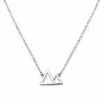 A Mountains and Valleys Necklace by Skōsh Jewelry, featuring an open outline of two mountain peaks set on a fine sterling silver chain, displayed against a white background.