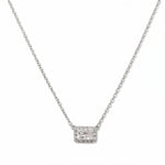 A Radiant Grace Rectangle White Cubic Zirconia with Halo Necklace by Skōsh Jewelry, featuring a rectangular emerald-cut clear stone surrounded by a halo of smaller stones on a fine sterling silver chain, displayed against a white background.