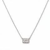 A Radiant Grace Rectangle White Cubic Zirconia with Halo Necklace by Skōsh Jewelry, featuring a rectangular emerald-cut clear stone surrounded by a halo of smaller stones on a fine sterling silver chain, displayed against a white background.