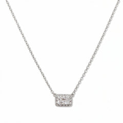 A Radiant Grace Rectangle White Cubic Zirconia with Halo Necklace by Skōsh Jewelry, featuring a rectangular emerald-cut clear stone surrounded by a halo of smaller stones on a fine sterling silver chain, displayed against a white background.