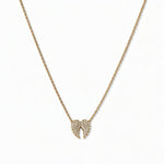 A Celestial Pavé White Cubic Zirconia Wings Necklace by Skōsh Jewelry, featuring a pair of angel wings covered in small clear pavé stones on a fine gold chain, displayed against a white background.