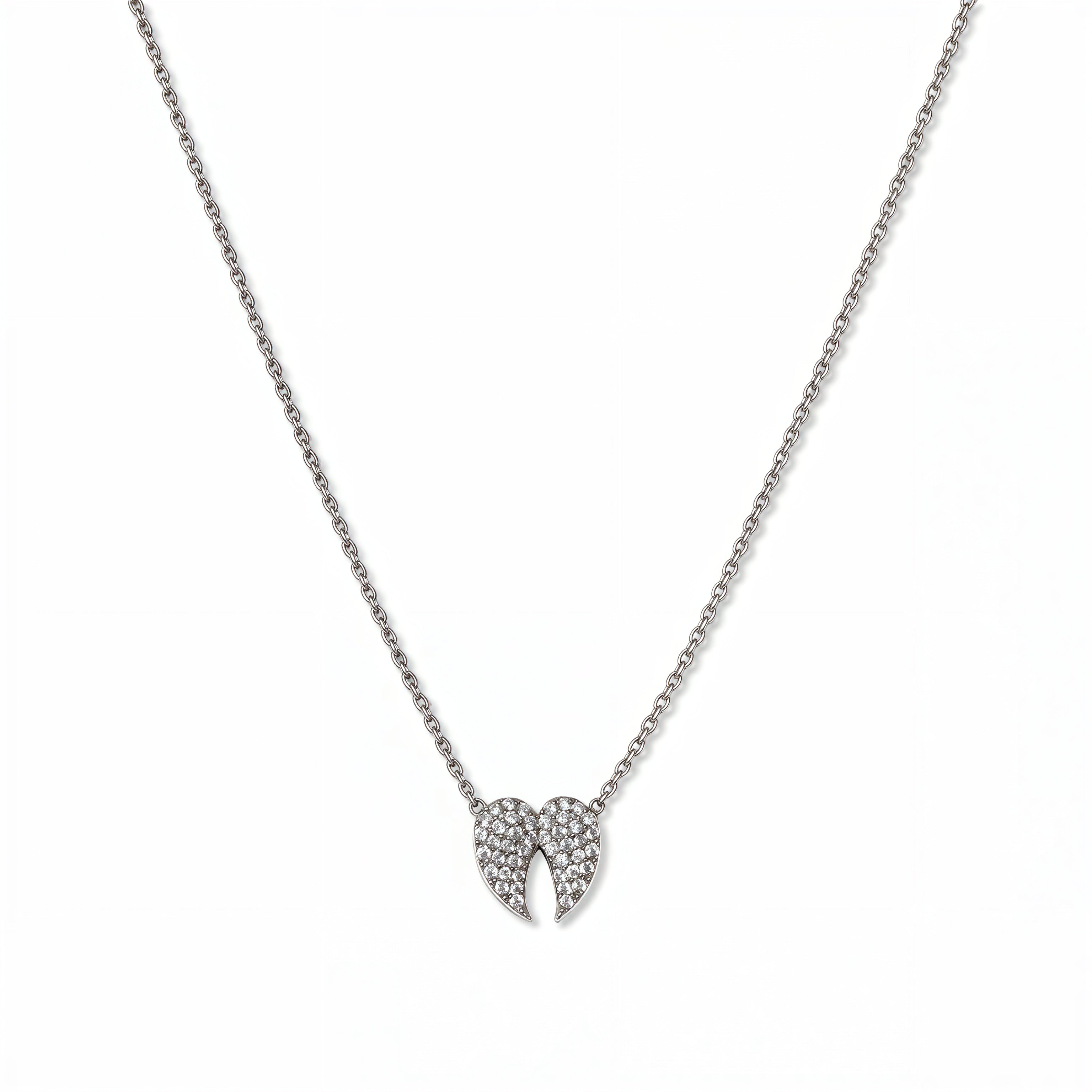 A Celestial Pavé White Cubic Zirconia Wings Necklace by Skōsh Jewelry, featuring a pair of angel wings covered in small clear pavé stones on a fine sterling silver chain, displayed against a white background.