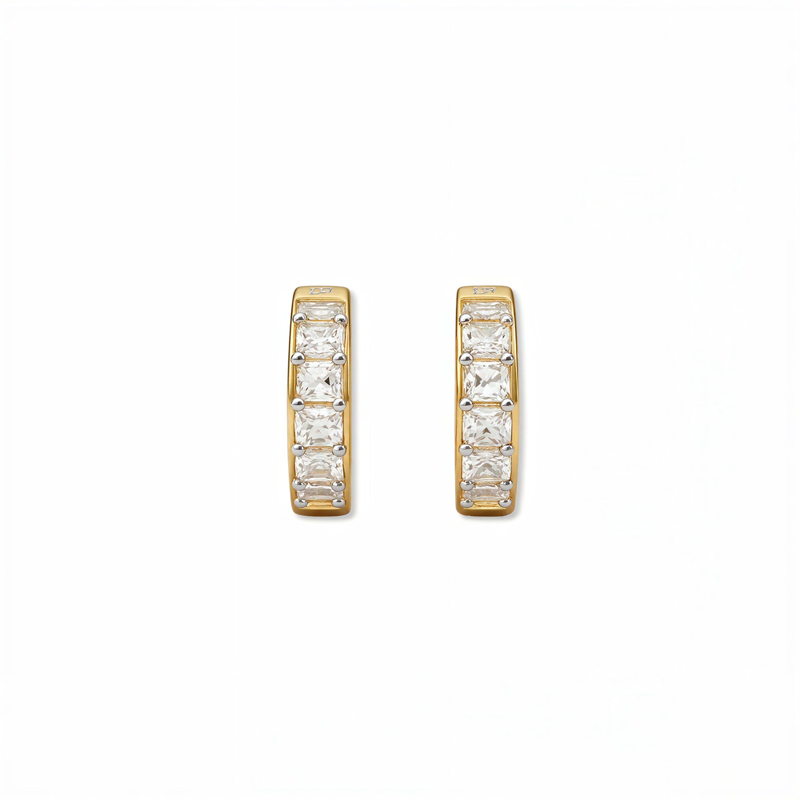 A pair of White Cubic Zirconia Huggie Hoop Earrings by Skōsh Jewelry, featuring small gold huggie hoops set with sparkling clear stones, displayed against a white background.
