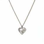A Heart, Sun & Moon with White Cubic Zirconia Pendant Necklace by Skōsh Jewelry, featuring an open heart framing a sun and crescent moon with clear stone accents on a fine sterling silver chain, displayed against a white background.