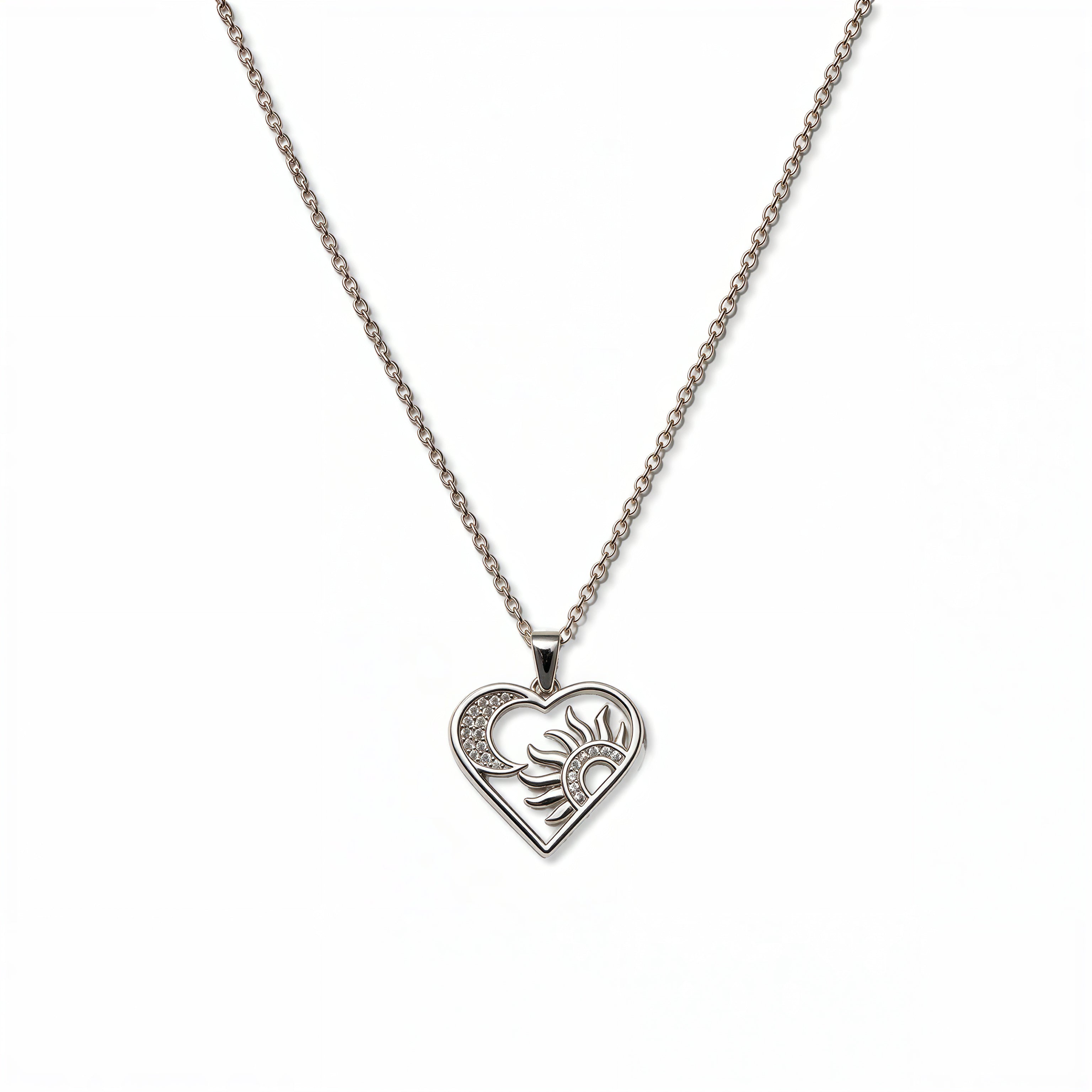 A Heart, Sun & Moon with White Cubic Zirconia Pendant Necklace by Skōsh Jewelry, featuring an open heart framing a sun and crescent moon with clear stone accents on a fine sterling silver chain, displayed against a white background.
