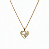 A Heart, Sun & Moon with White Cubic Zirconia Pendant Necklace by Skōsh Jewelry, featuring an open heart framing a sun and crescent moon with clear stone accents on a fine gold chain, displayed against a white background.