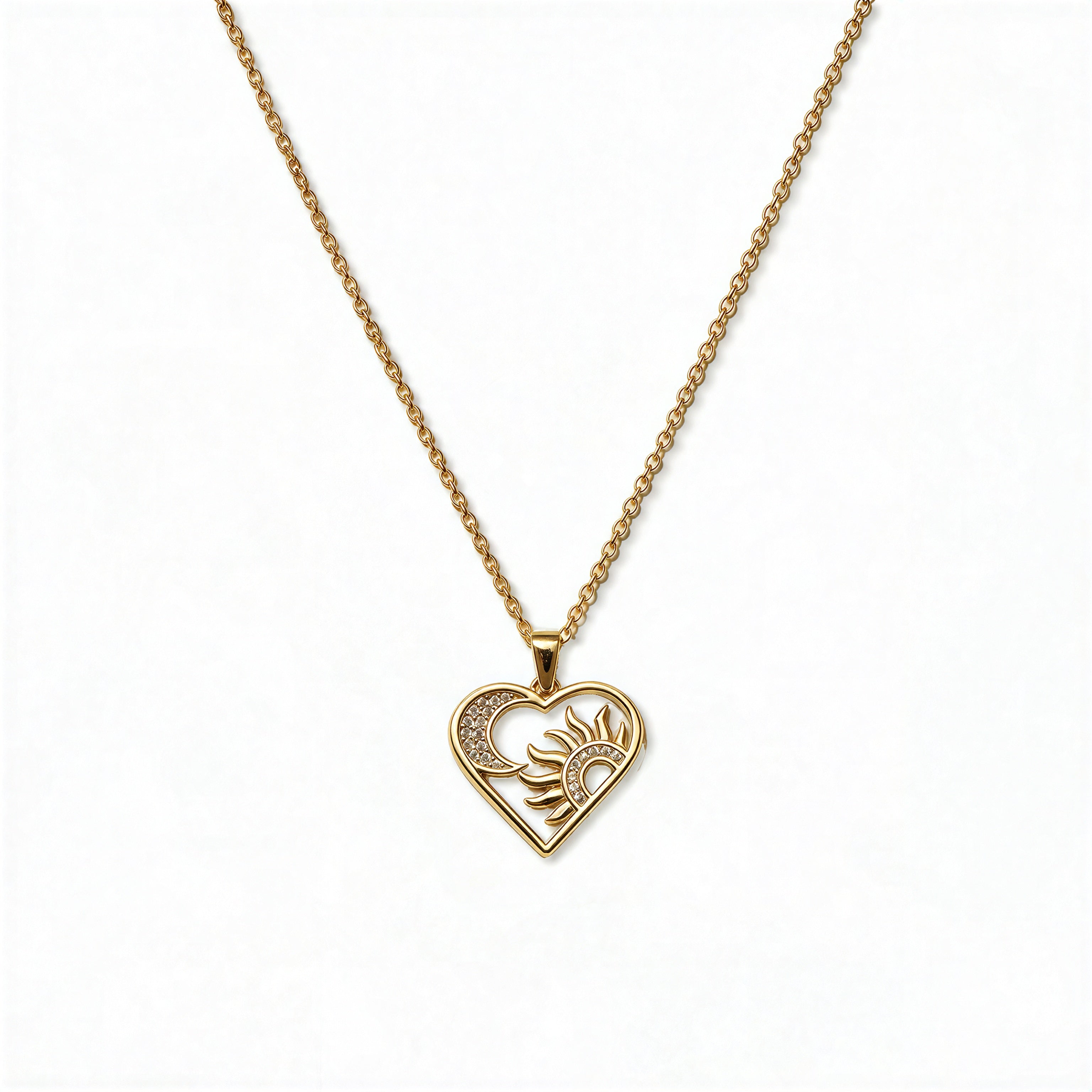 A Heart, Sun & Moon with White Cubic Zirconia Pendant Necklace by Skōsh Jewelry, featuring an open heart framing a sun and crescent moon with clear stone accents on a fine gold chain, displayed against a white background.