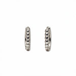 A pair of Beaded Huggie Hoop Earrings by Skōsh Jewelry, featuring small sterling silver huggie hoops with a beaded texture, displayed against a white background.