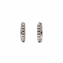 A pair of Beaded Huggie Hoop Earrings by Skōsh Jewelry, featuring small sterling silver huggie hoops with a beaded texture, displayed against a white background.