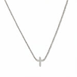 An Endless Faith Mini Cross with White Cubic Zirconia Necklace by Skōsh Jewelry, featuring a petite cross lined with small clear stones set on a fine sterling silver chain, displayed against a white background.