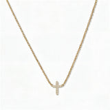 An Endless Faith Mini Cross with White Cubic Zirconia Necklace by Skōsh Jewelry, featuring a petite cross lined with small clear stones set on a fine gold chain, displayed against a white background.