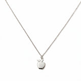 An Apple Pendant Necklace by Skōsh Jewelry, featuring a small polished apple pendant with a leaf on a fine sterling silver chain, displayed against a white background.