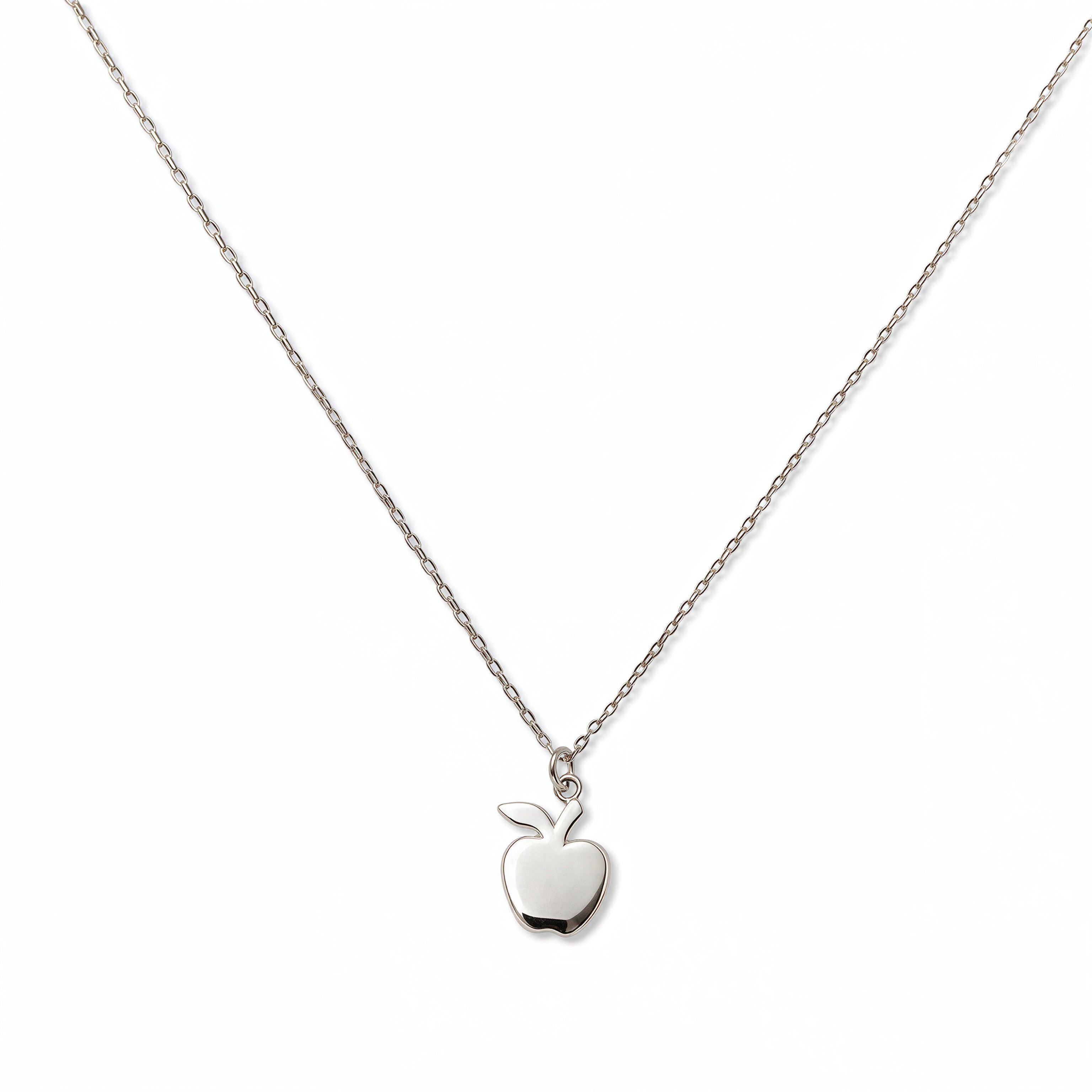 An Apple Pendant Necklace by Skōsh Jewelry, featuring a small polished apple pendant with a leaf on a fine sterling silver chain, displayed against a white background.