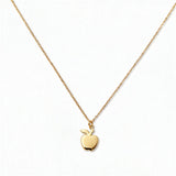 An Apple Pendant Necklace by Skōsh Jewelry, featuring a small polished apple pendant with a leaf on a fine gold chain, displayed against a white background.