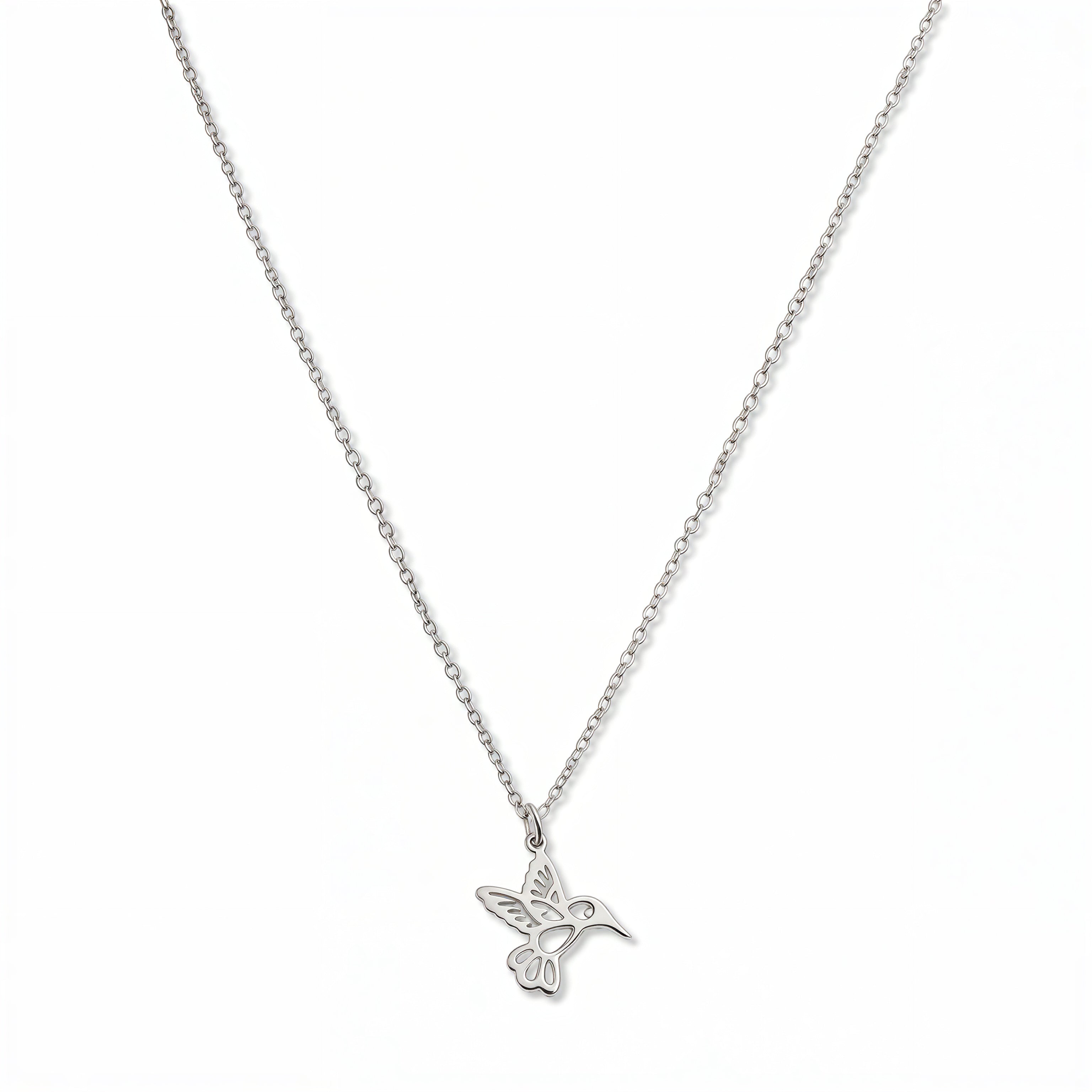 A Hummingbird Pendant Necklace by Skōsh Jewelry, featuring a small hummingbird in flight on a fine sterling silver chain, displayed against a white background.