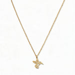 A Hummingbird Pendant Necklace by Skōsh Jewelry, featuring a small hummingbird in flight on a fine gold chain, displayed against a white background.