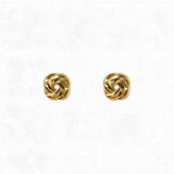 A pair of Knotted Stud Earrings by Skōsh Jewelry, featuring polished gold studs shaped like twisted love knots, displayed against a white background.