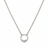 A Trio White Cubic Zirconia Accent Circle Necklace by Skōsh Jewelry, featuring a small open circle accented with three clear stones on a fine sterling silver chain, displayed against a white background.