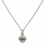 A Seashell Pendant Necklace by Skōsh Jewelry, featuring a ridged scallop seashell pendant on a fine sterling silver chain, displayed against a white background.