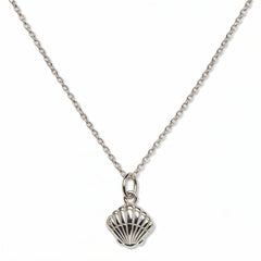 A Seashell Pendant Necklace by Skōsh Jewelry, featuring a ridged scallop seashell pendant on a fine sterling silver chain, displayed against a white background.