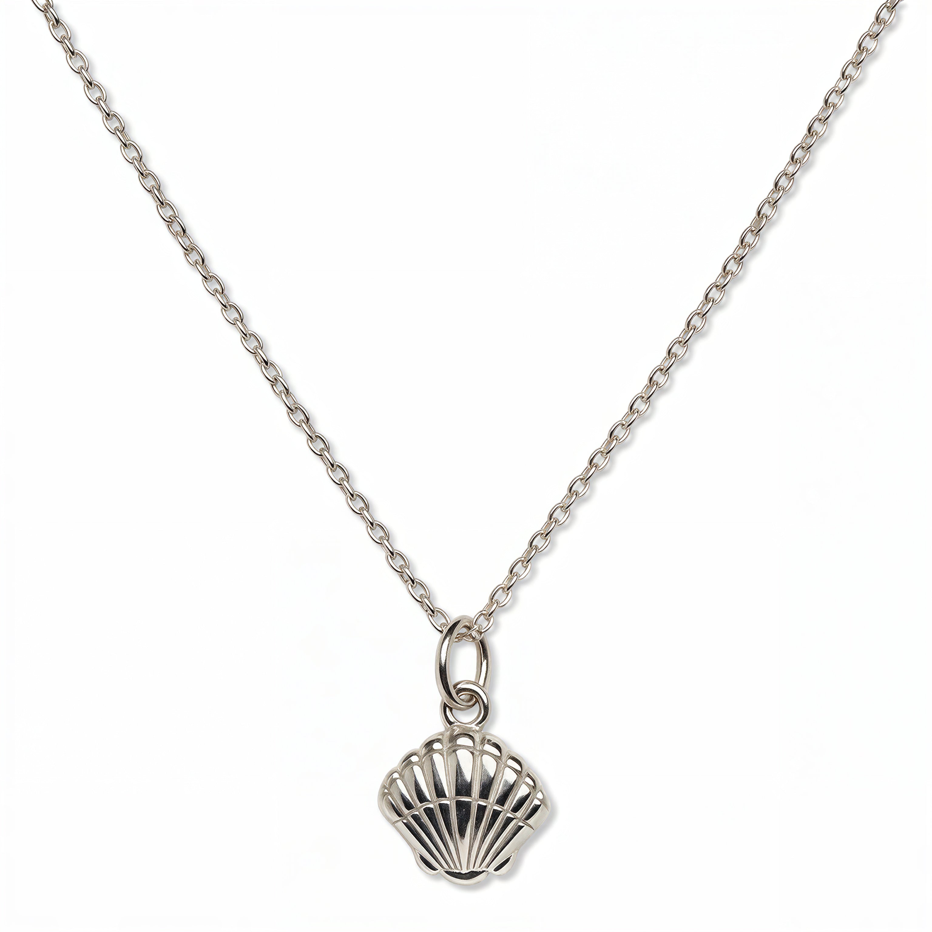 A Seashell Pendant Necklace by Skōsh Jewelry, featuring a ridged scallop seashell pendant on a fine sterling silver chain, displayed against a white background.