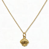 A Seashell Pendant Necklace by Skōsh Jewelry, featuring a ridged scallop seashell pendant on a fine gold chain, displayed against a white background.