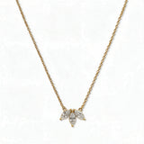 A Triple Marquise Cut White Cubic Zirconia Necklace by Skōsh Jewelry, featuring three marquise-cut clear stones fanned in a row on a fine gold chain, displayed against a white background.