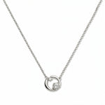 A Karma Double White Cubic Zirconia Accent Circle Necklace by Skōsh Jewelry, featuring an open circle with two clear stone accents on a fine sterling silver chain, displayed against a white background.