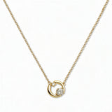 A Karma Double White Cubic Zirconia Accent Circle Necklace by Skōsh Jewelry, featuring an open circle with two clear stone accents on a fine gold chain, displayed against a white background.