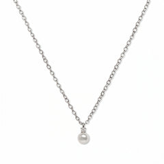 A Classic Drop Pearl with White Cubic Zirconia Accent Necklace by Skōsh Jewelry, featuring a round white freshwater pearl drop topped with a small clear stone on a fine sterling silver chain, displayed against a white background.