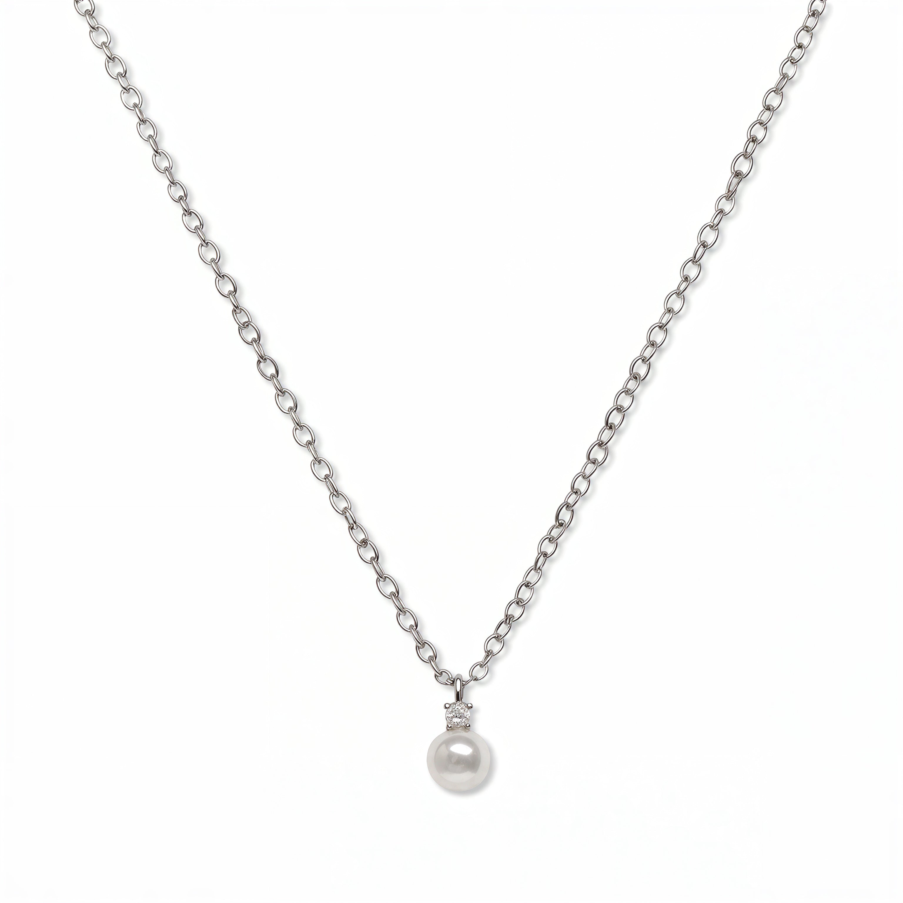 A Classic Drop Pearl with White Cubic Zirconia Accent Necklace by Skōsh Jewelry, featuring a round white freshwater pearl drop topped with a small clear stone on a fine sterling silver chain, displayed against a white background.