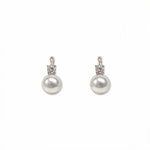 A pair of Classic Pearl with White Cubic Zirconia Accent Earrings by Skōsh Jewelry, featuring round white freshwater pearl drops topped with small clear stones in sterling silver, displayed against a white background.