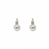 A pair of Classic Pearl with White Cubic Zirconia Accent Earrings by Skōsh Jewelry, featuring round white freshwater pearl drops topped with small clear stones in sterling silver, displayed against a white background.