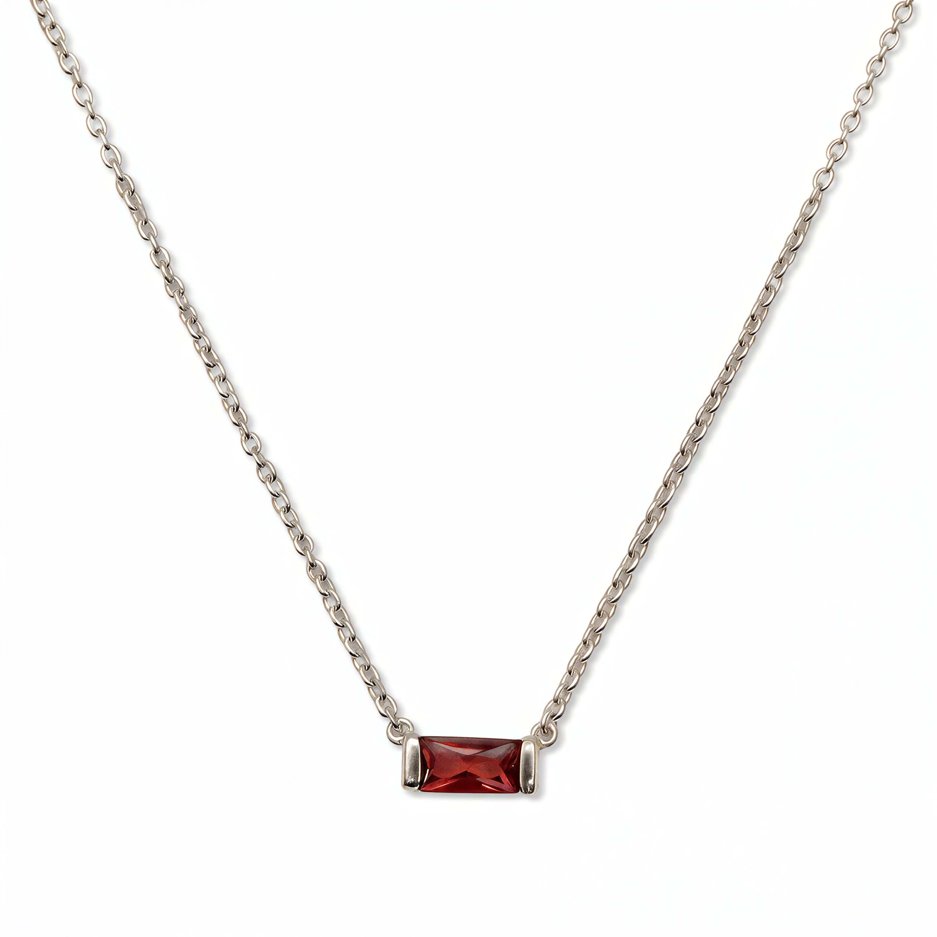 A January Birthstone Garnet Cubic Zirconia Baguette Necklace by Skōsh Jewelry, featuring a slim rectangular deep red baguette stone set horizontally on a fine sterling silver chain, displayed against a white background.