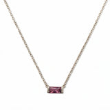 A February Birthstone Amethyst Cubic Zirconia Baguette Necklace by Skōsh Jewelry, featuring a slim rectangular purple baguette stone set horizontally on a fine sterling silver chain, displayed against a white background.