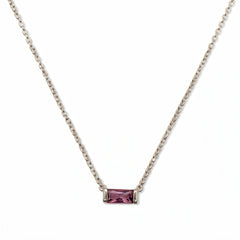 A February Birthstone Amethyst Cubic Zirconia Baguette Necklace by Skōsh Jewelry, featuring a slim rectangular purple baguette stone set horizontally on a fine sterling silver chain, displayed against a white background.