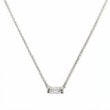 An April Birthstone White Cubic Zirconia Baguette Necklace by Skōsh Jewelry, featuring a slim rectangular clear baguette stone set horizontally on a fine sterling silver chain, displayed against a white background.