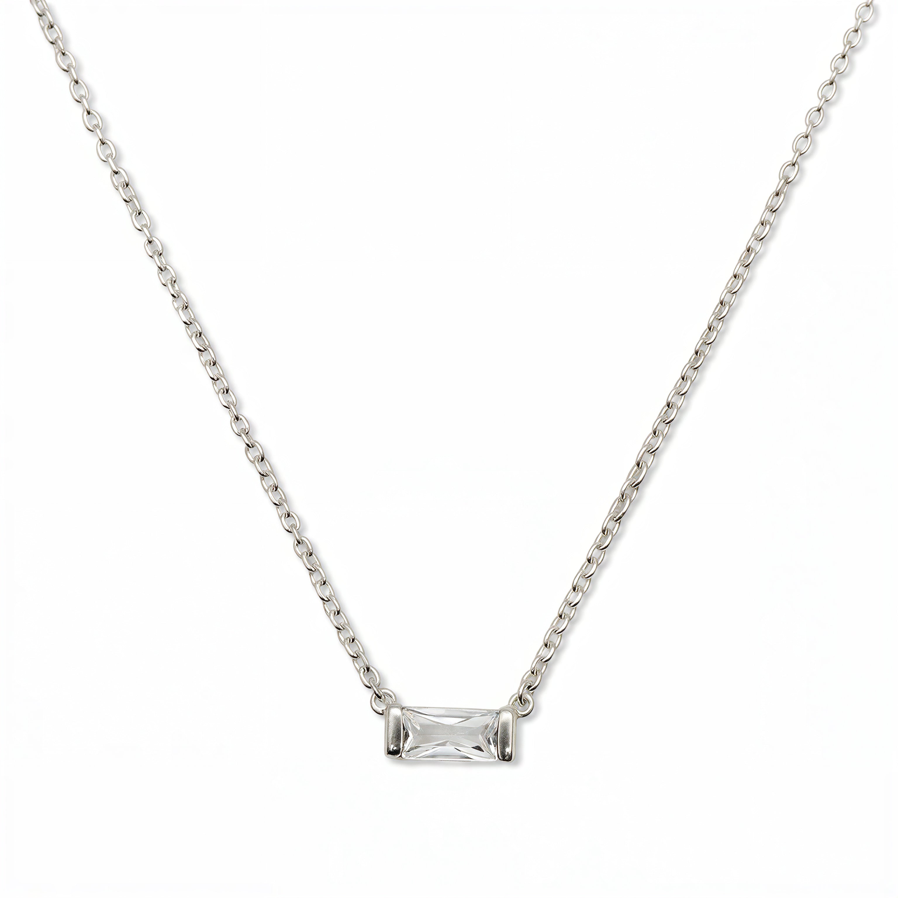 An April Birthstone White Cubic Zirconia Baguette Necklace by Skōsh Jewelry, featuring a slim rectangular clear baguette stone set horizontally on a fine sterling silver chain, displayed against a white background.