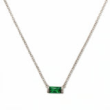 A May Birthstone Emerald Cubic Zirconia Baguette Necklace by Skōsh Jewelry, featuring a slim rectangular green baguette stone set horizontally on a fine sterling silver chain, displayed against a white background.