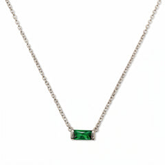 A May Birthstone Emerald Cubic Zirconia Baguette Necklace by Skōsh Jewelry, featuring a slim rectangular green baguette stone set horizontally on a fine sterling silver chain, displayed against a white background.