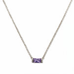 A June Birthstone Lavender Cubic Zirconia Baguette Necklace by Skōsh Jewelry, featuring a slim rectangular light purple baguette stone set horizontally on a fine sterling silver chain, displayed against a white background.