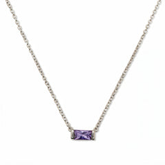 A June Birthstone Lavender Cubic Zirconia Baguette Necklace by Skōsh Jewelry, featuring a slim rectangular light purple baguette stone set horizontally on a fine sterling silver chain, displayed against a white background.