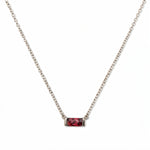 A July Birthstone Ruby Cubic Zirconia Baguette Necklace by Skōsh Jewelry, featuring a slim rectangular red baguette stone set horizontally on a fine sterling silver chain, displayed against a white background.