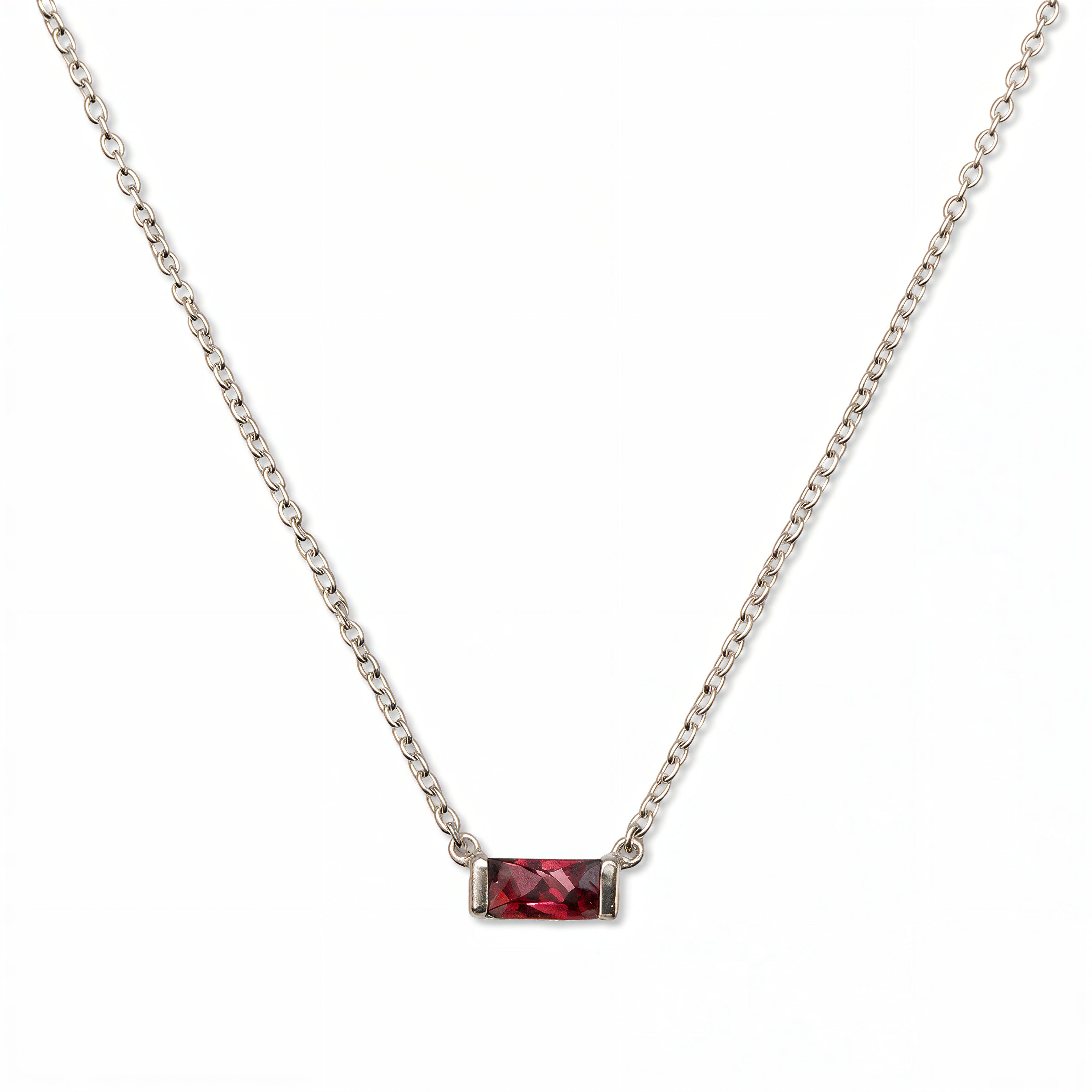 A July Birthstone Ruby Cubic Zirconia Baguette Necklace by Skōsh Jewelry, featuring a slim rectangular red baguette stone set horizontally on a fine sterling silver chain, displayed against a white background.